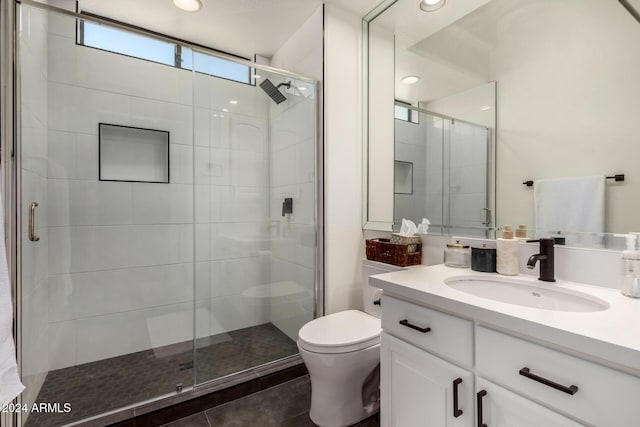 bathroom with vanity, an enclosed shower, tile patterned flooring, and toilet