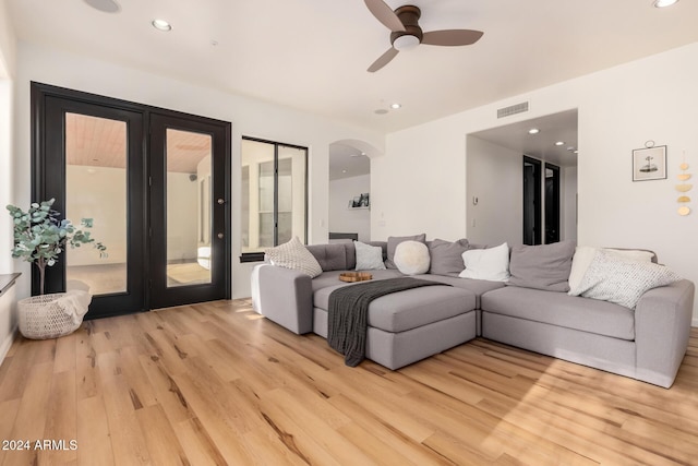 living room featuring ceiling fan and light hardwood / wood-style flooring