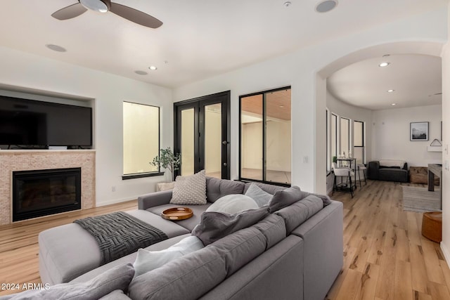 living room with ceiling fan and light wood-type flooring