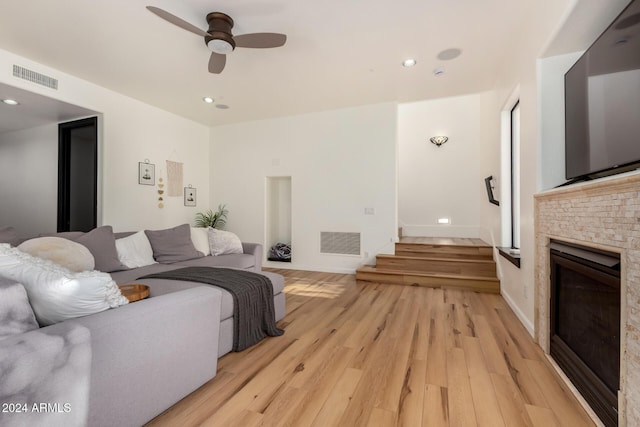 living room featuring ceiling fan and light wood-type flooring