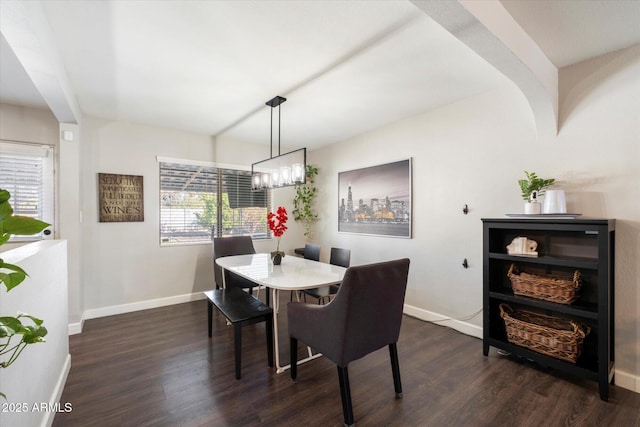 dining area with an inviting chandelier and dark hardwood / wood-style floors