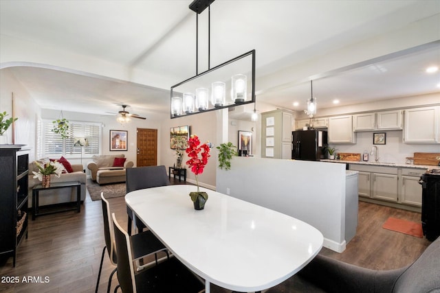 dining area with sink, ceiling fan, and dark hardwood / wood-style floors