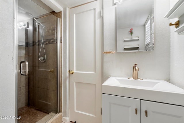 bathroom with walk in shower and vanity