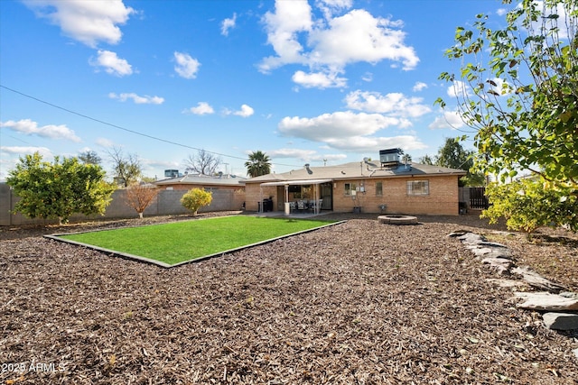 back of property featuring a patio, a yard, and central AC unit