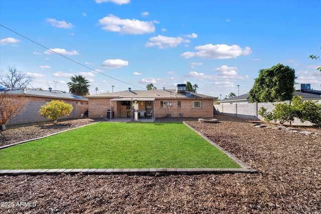 back of house with cooling unit, a yard, and a patio area