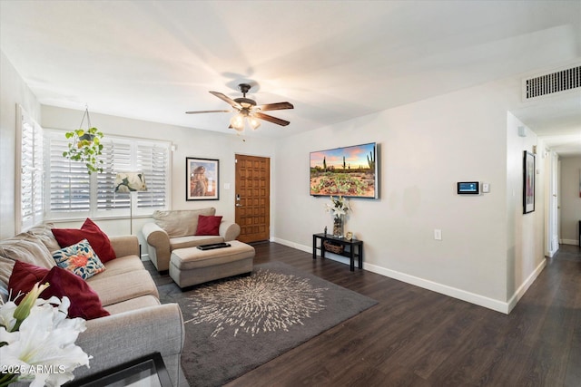 living room featuring ceiling fan and dark wood-type flooring