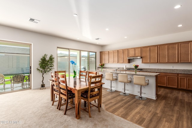 dining space featuring dark hardwood / wood-style flooring and sink