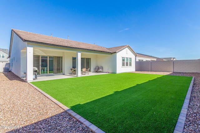 back of house with a yard, central AC, and a patio