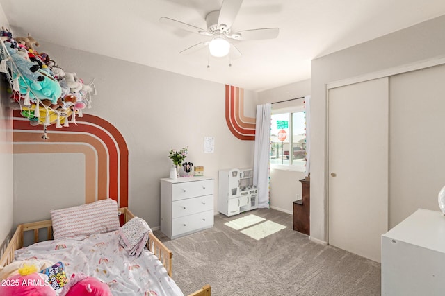 carpeted bedroom featuring a closet and ceiling fan