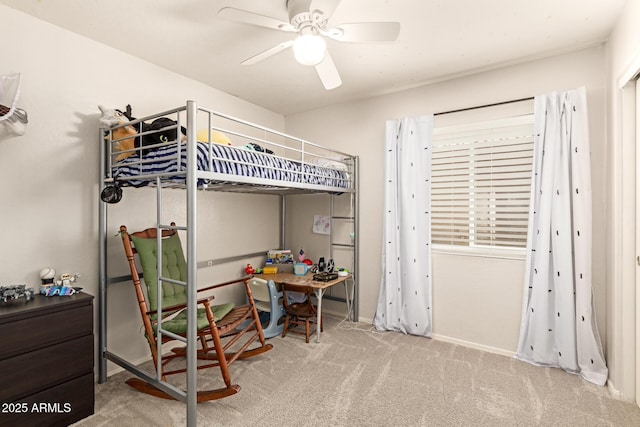 bedroom with a ceiling fan and carpet