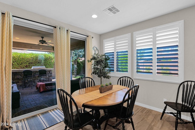 dining room with ceiling fan and light hardwood / wood-style flooring