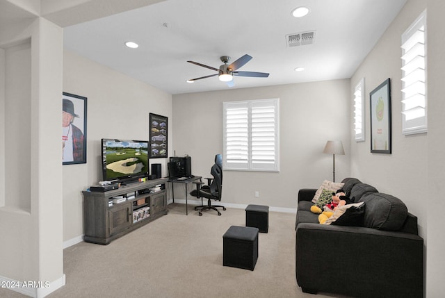 carpeted living room with ceiling fan