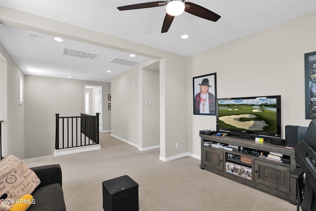 carpeted living room with ceiling fan