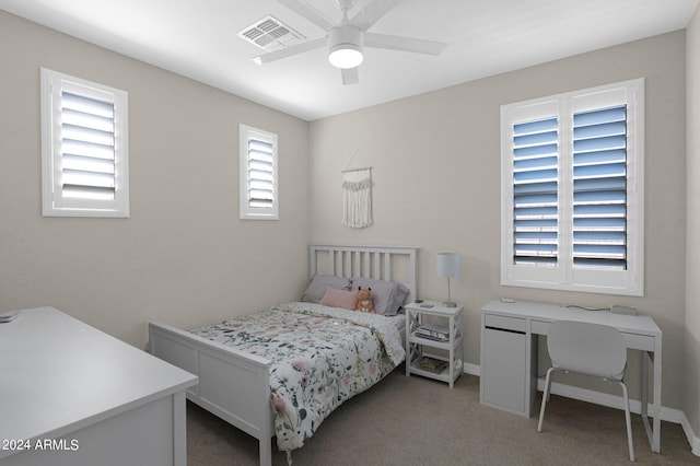 carpeted bedroom featuring ceiling fan and multiple windows