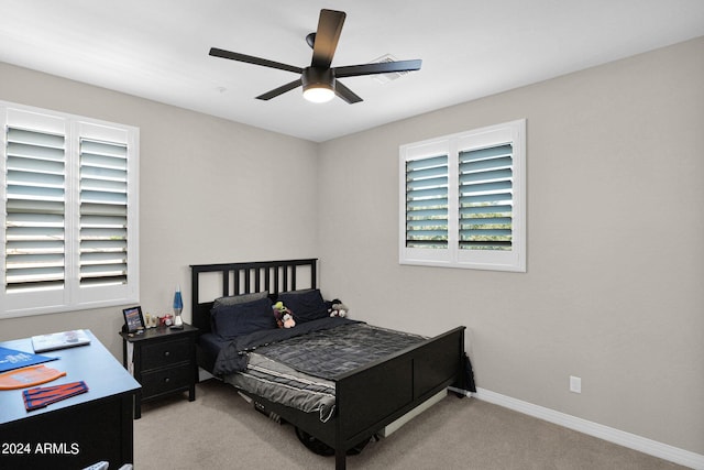 bedroom featuring light carpet and ceiling fan