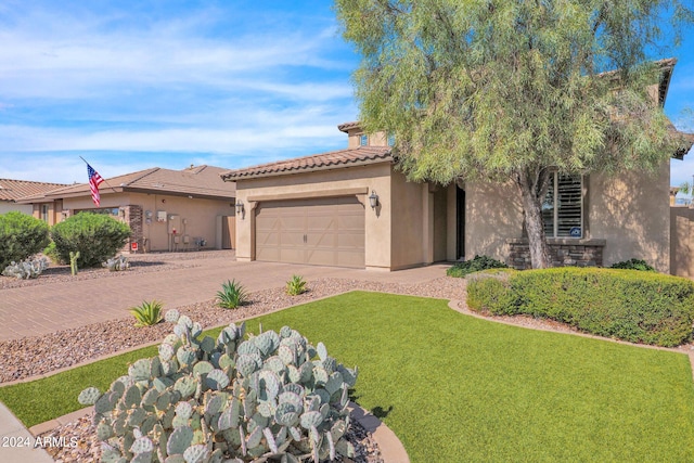 view of front of property with a garage and a front yard