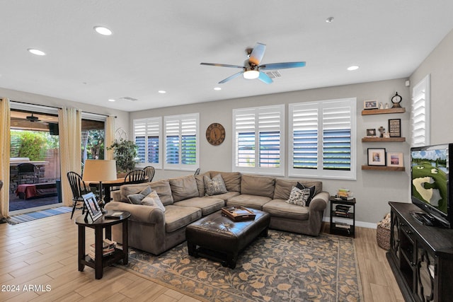 living room with ceiling fan and light wood-type flooring