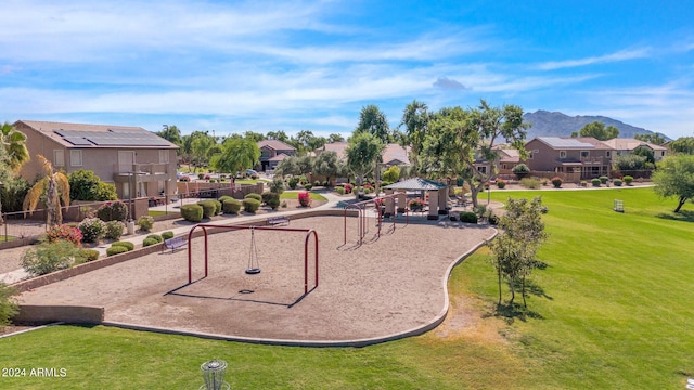 surrounding community featuring a gazebo, a yard, a playground, and a mountain view