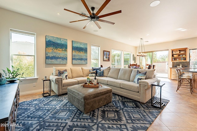 living room with ceiling fan and tile patterned floors