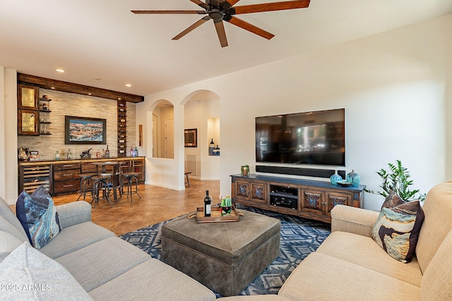 tiled living room featuring beverage cooler and ceiling fan