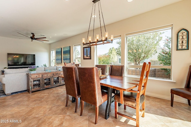 dining room featuring ceiling fan with notable chandelier