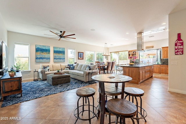 living room featuring light tile patterned floors and ceiling fan