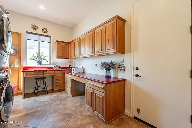 kitchen featuring stacked washer / drying machine and built in desk