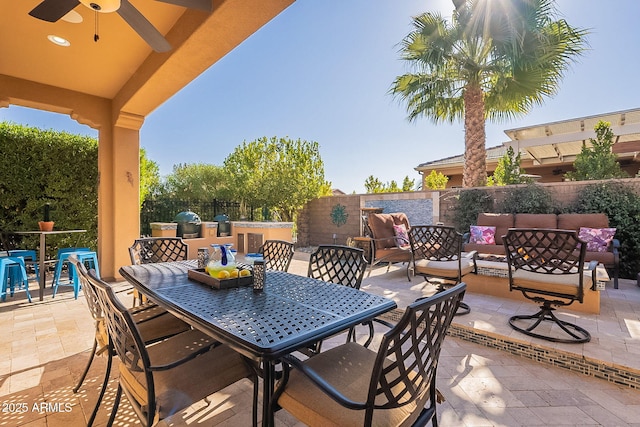 view of patio / terrace with an outdoor kitchen, ceiling fan, and outdoor lounge area