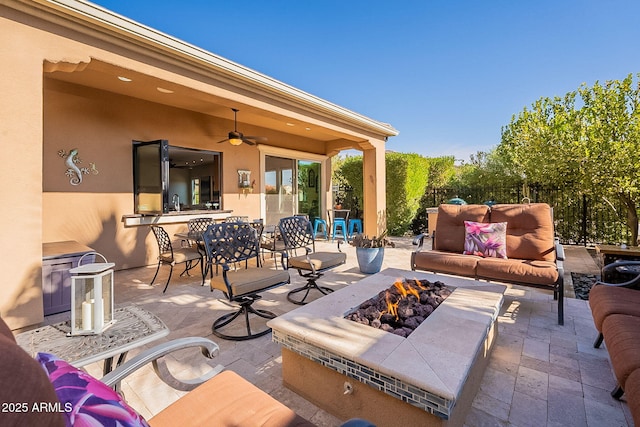 view of patio featuring an outdoor living space with a fire pit and ceiling fan