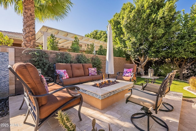 view of patio with an outdoor living space with a fire pit