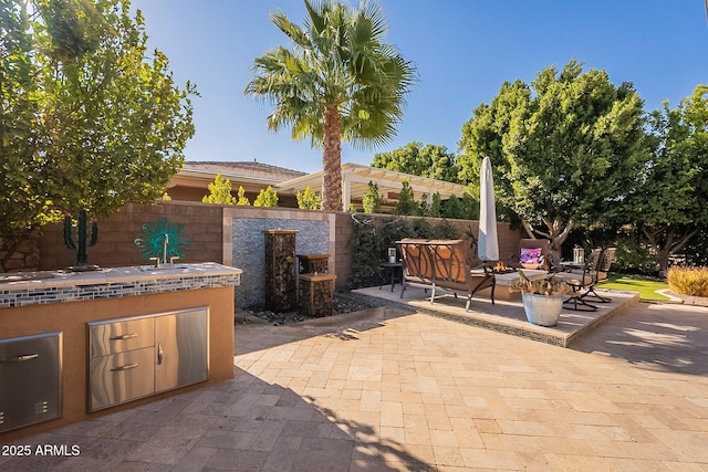 view of patio / terrace featuring sink and exterior kitchen