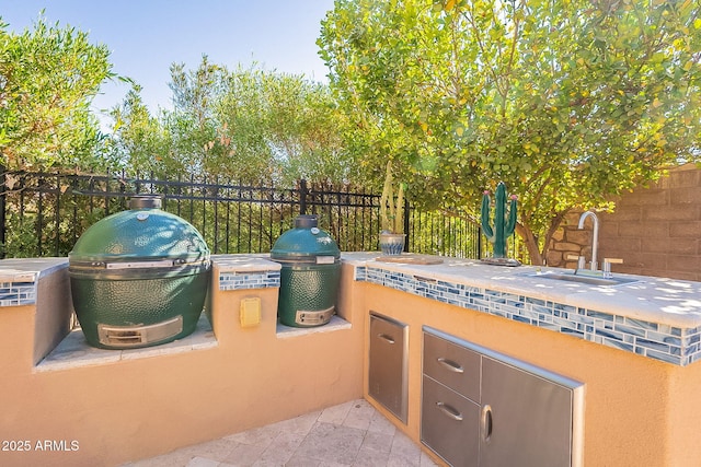 view of patio / terrace with a grill, area for grilling, and sink