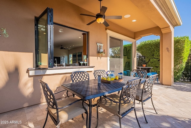 view of patio / terrace featuring sink and ceiling fan