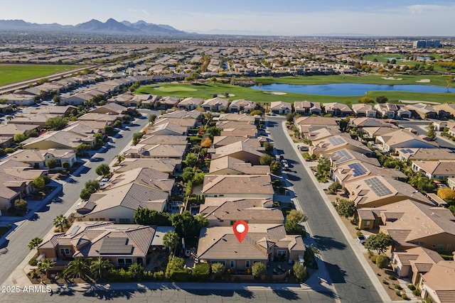 drone / aerial view with a water and mountain view