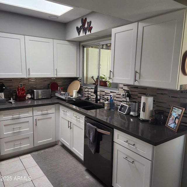 kitchen with dishwasher, sink, white cabinets, decorative backsplash, and light tile patterned floors