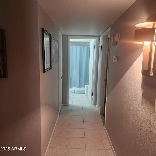 hall featuring light tile patterned floors