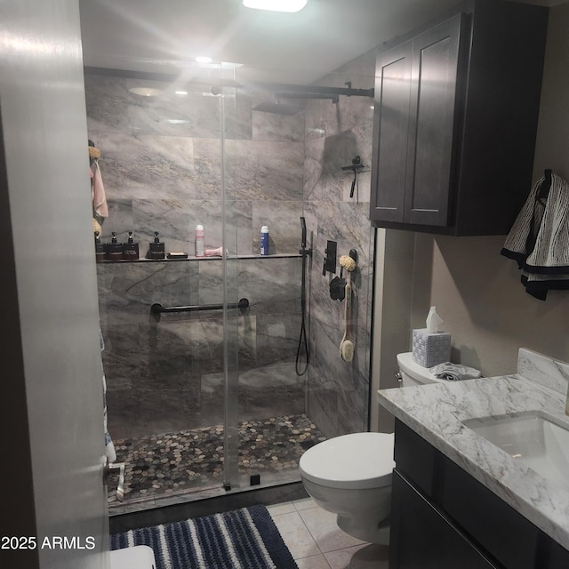 bathroom featuring vanity, toilet, tile patterned floors, and walk in shower