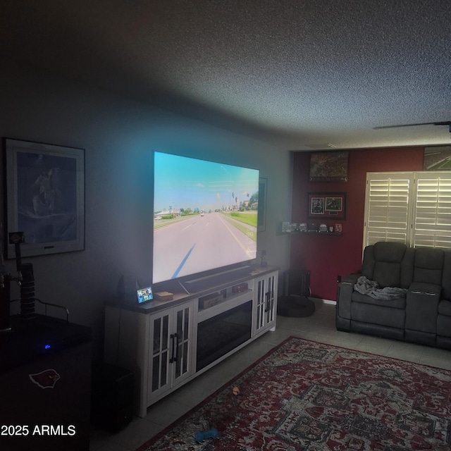 living room with tile patterned floors and a textured ceiling