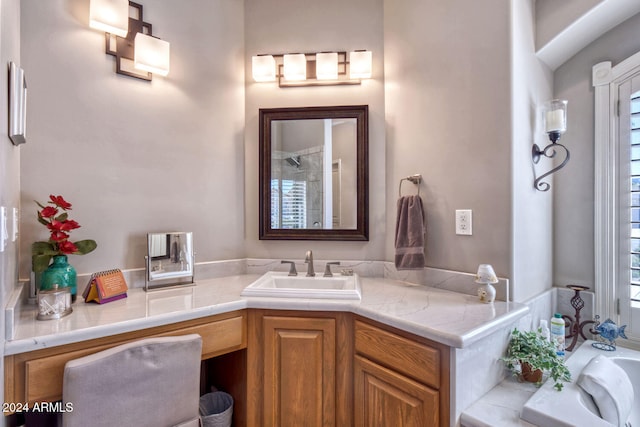 bathroom with vanity and a tub