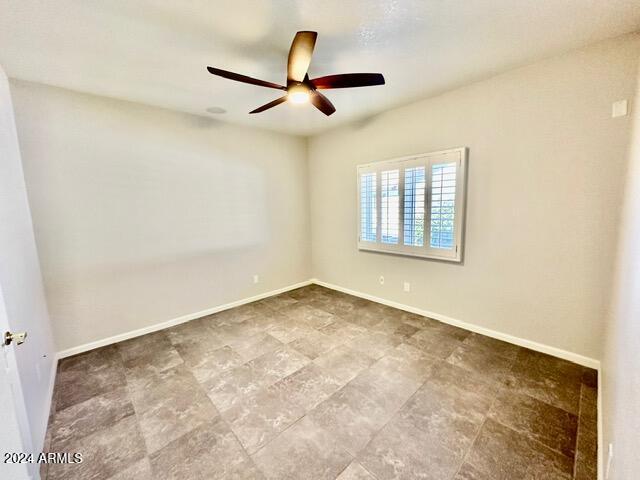 unfurnished room featuring ceiling fan