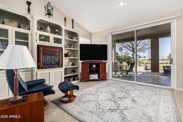 sitting room featuring lofted ceiling and tile patterned flooring