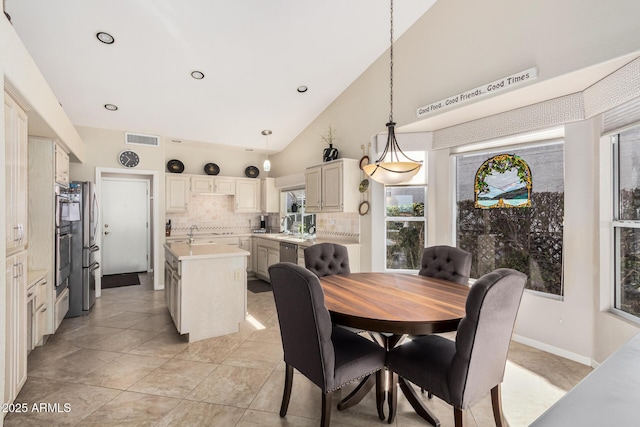 dining area featuring baseboards, visible vents, light tile patterned flooring, high vaulted ceiling, and recessed lighting