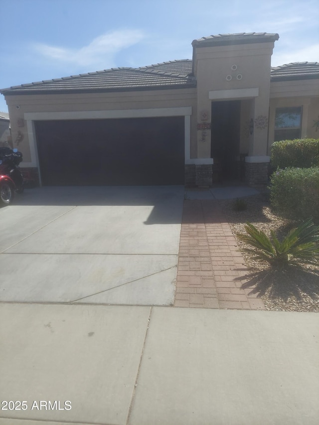 view of front of property featuring concrete driveway and an attached garage