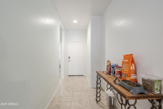 corridor featuring recessed lighting, light tile patterned flooring, and baseboards