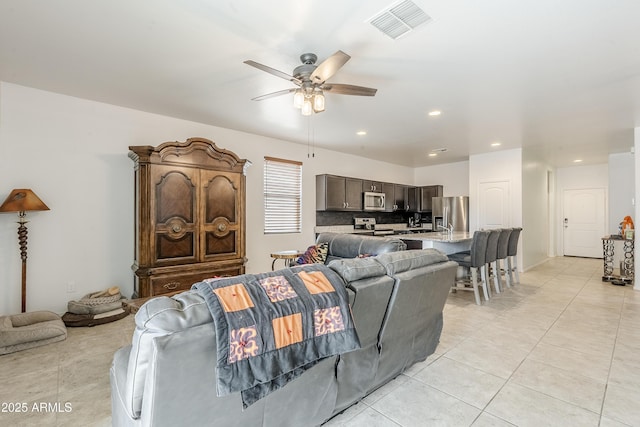 living room featuring recessed lighting, visible vents, ceiling fan, and light tile patterned floors