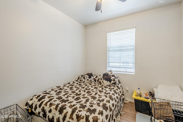 bedroom with ceiling fan and wood finished floors