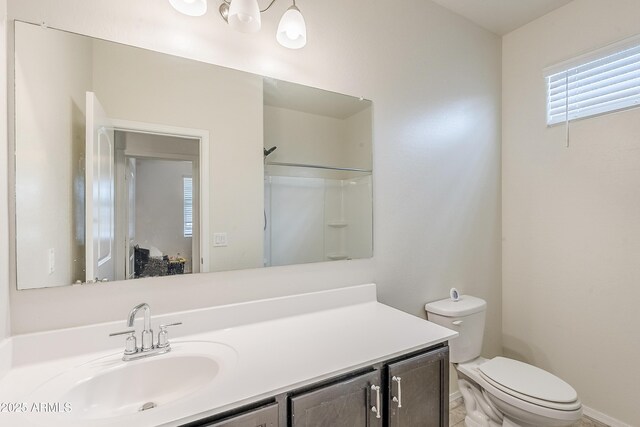 full bathroom featuring vanity, toilet, and walk in shower