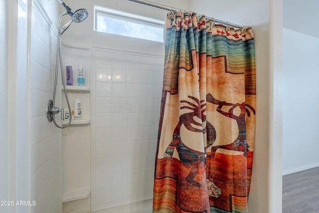 bathroom featuring a shower with shower curtain and wood finished floors