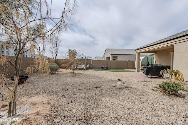 view of yard featuring a patio area and a fenced backyard