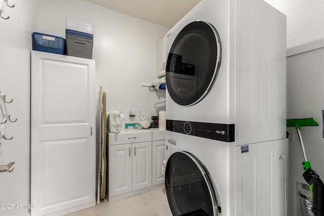 10545 E Texas Ave, Mesa, AZ 85212 - laundry area with stacked washer / dryer, cabinet space, and light tile patterned floors